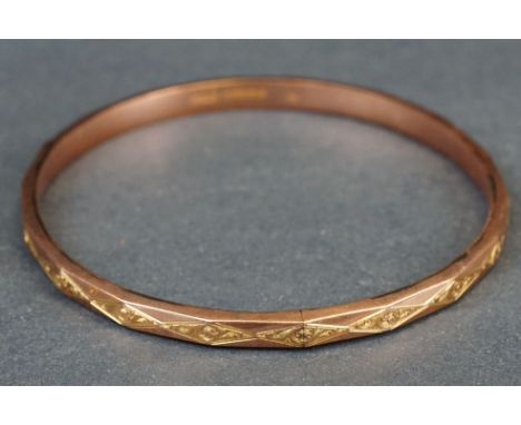 9ct rose gold slave bangle, engraved foliate scroll decoration to repeating lozenge shapes, width approx 5mm, internal circum