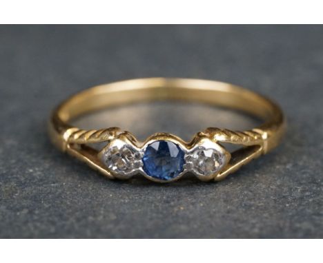 Sapphire and diamond three stone 18ct yellow gold ring, the central small round mixed cut blue sapphire diameter approx 3mm, 