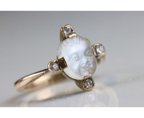 Victorian / Edwardian moonstone and diamond ring, the cabochon cut oval moonstone with carved child's face, claw set, small r
