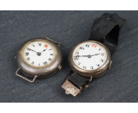 An early 20th century silver watch, white enamel dial with black and red Roman numerals, London import marks for 1917, togeth