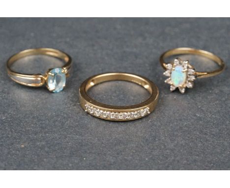 Three gold rings comprising an opal and diamond 10ct yellow gold and white gold set cluster ring, the precious white opal dis
