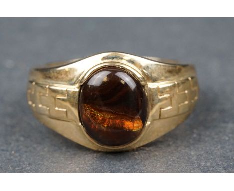Boulder opal 9ct yellow gold ring, the oval cabochon cut boulder opal measuring approx 12mm x 10mm, collet set, textured tape