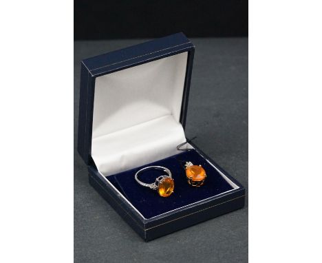 Fire opal and diamond 18ct white gold ring, the oval mixed cut fire opal measuring approx 11mm x 9mm, three small round brill