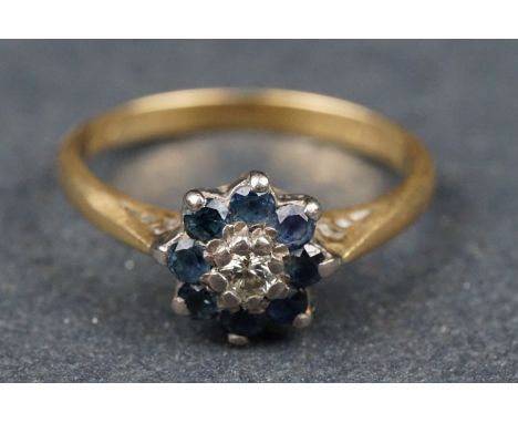 Sapphire and diamond 19ct yellow gold and white gold set flower head ring, the small round brilliant cut diamond weighing app
