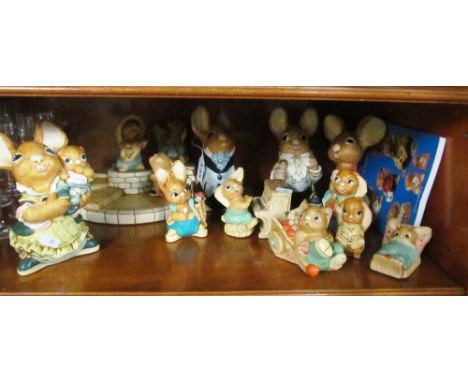 A group of four large Pendelfin rabbits, a stand, Pendelfin rabbit playing the piano, seven other Pendelfin rabbits and a col