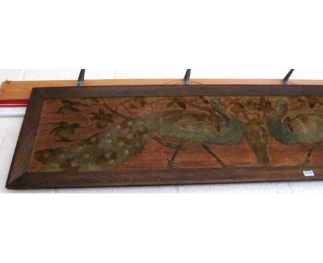 A wide peacock tapestry in oak frame
