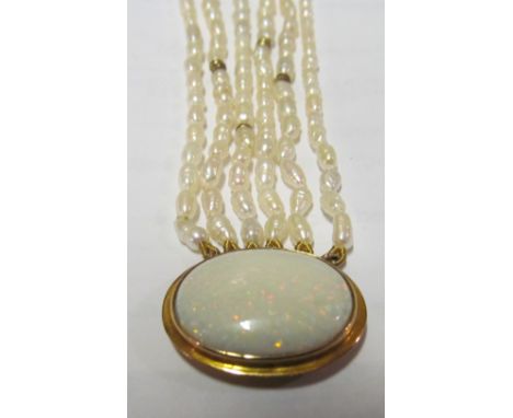 A six string pearl necklace with oval opal clasp