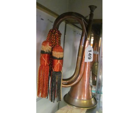 A copper and brass bugle with tassel