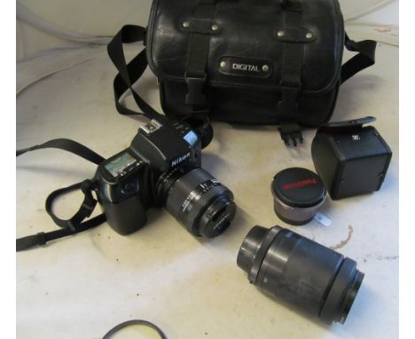 A Nikon F70 camera with Nikon lense and Tamron lense (i.c)