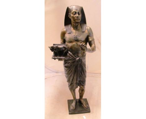 A bronze of an Egyptian figure holding sacred cow on plinth base 28" high