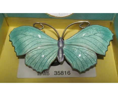 A sterling silver and green enamel butterfly brooch