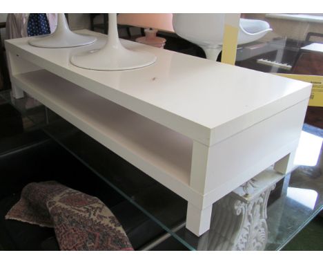 A modern long white coffee table with shelf under 15.5”