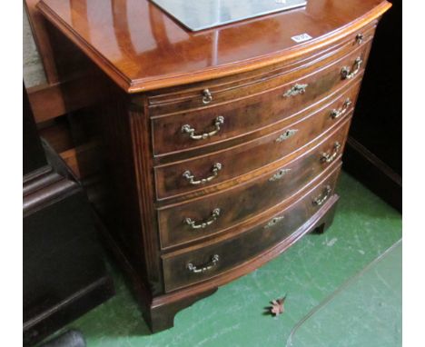 A mahogany and walnut bow front chest with brushing slide above four graduated drawers and bracket feet 33”w