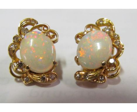 A pair of 585 earrings set opal and small diamonds