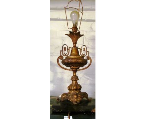 A lamp in the form of a gilt urn shaped vase on marble base