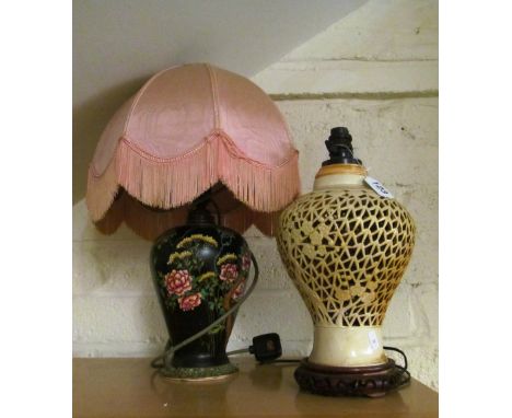 A cream oriental pierced lamp and another flowers on a black ground