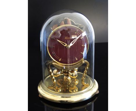 A German glass domed Kundo mantle clock, 20th century. H17cm. (2)
In-house packing &amp; shipping in the EU at €51.