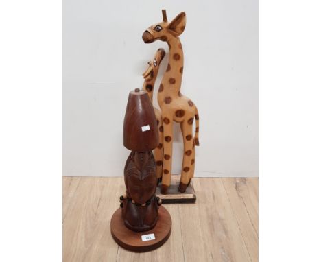 CARVED TRIBAL BUST TABLE LAMP BASE TOGETHER WITH PAINTED AND CARVED GIRAFFES