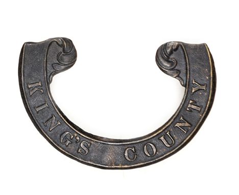 An Irish Militia brass scroll badge, for 1858 round forage cap, of the King’s County R Rifles (1253). GC (dark patina). Plate