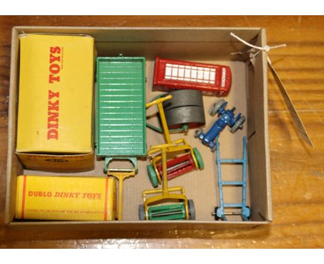 A small quantity of Dinky Toys. A Field-Marshall Tractor (301) in orange. A Hand Cart in green with yellow wheels and handle.