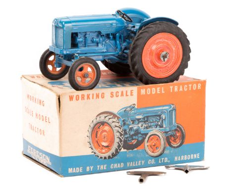 A scarce Chad Valley Fordson Tractor. A mechanical ‘working scale model’ finished in mid blue with orange wheels, with clockw