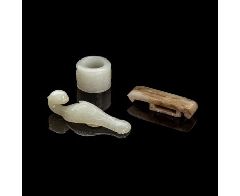 明至二十世紀 白玉雕鳳形帶鉤、白玉扳指及黃白玉劍璏（一組三件） comprising: a Qing dynasty white jade belt hook in the form of a phoenix, with its head formi