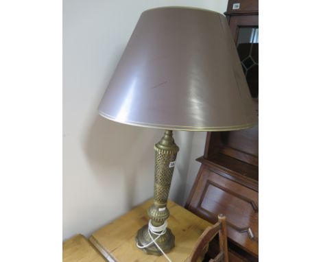 An unusual brass table lamp, pierced column in the Eastern style, with shade