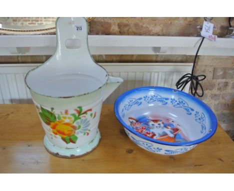 An enamel kitchen bucket with pouring sprout and slot for hanging decorated with painted flowers - good condition