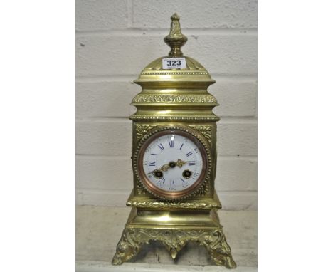 An 8 Day Brass French Mantle Clock with Gilt Hand and Dial showing hours and minutes - 14" tall