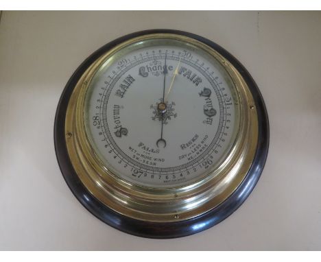 A mahogany and brass bulkhead aneroid barometer - 27cm diameter