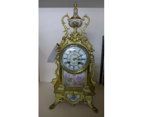 A 19th Century Gilt Mantle clock with a porcelain dial, striking on a gong - with the pendulum and key