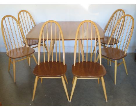 A Blonde Ercol Drop Leaf Dining Table and Six Stick Back Dining Chairs