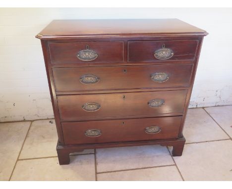 A Georgian mahogany chest with two short over three long drawers raised on bracket feet and canted corner - in good condition