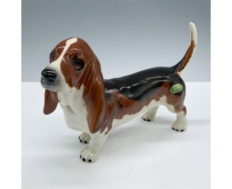 Glazed finish. Features a white, brown and black dog. Beswick backstamp. Dimensions: 7.75''L x 2.5''W x 5''HManufacturer: Bes