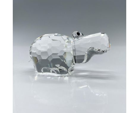 The hippo is made from clear crystal and has small black eyes and a frosted crystal tail. Swarovski backstamp. This item has 