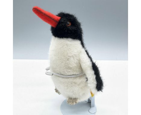 Adorable piece. Features a classic penguin appearance with a black and white color scheme. Steiff gold button on wing and tag