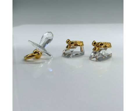 2pc Swarovski Crystal Memories Figures, Pacifier 168677 and Baby Shoes 209453. A set of two crystal items decorated with gold