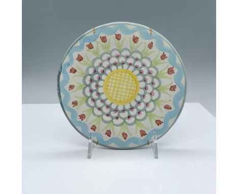 Beautiful ceramic plate decorated with flowers in pastel colors. Wire plate hanger attached. The back is stamped with the Vic