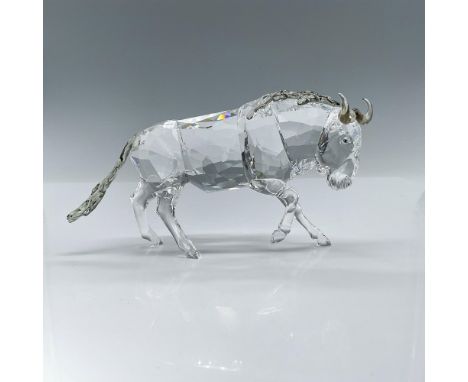 This crystal charging gnu figurine was part of the Rare Encounters group. It is made of clear faceted crystal with smoky quar