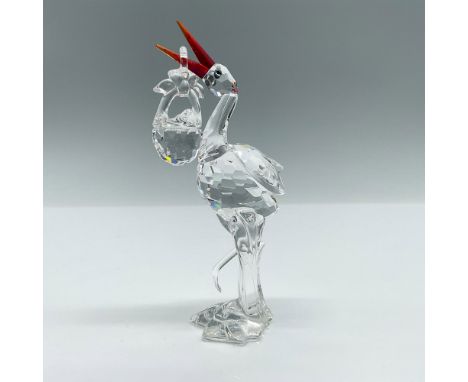 Part of the Cheerful Times group. A clear faceted stork with red-orange beak and green-yellow eyes. The clear baby basket is 