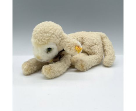 This adorable ecru colored Lamby has the yellow ear tag with number -73151, chest label with the Lamby name and brown ribbon 