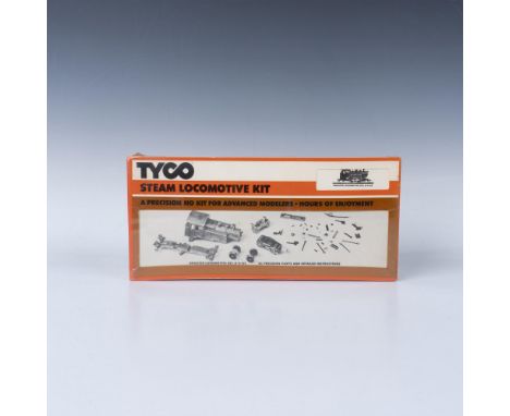 A sealed box containing a Tyco steam locomotive, complete with a booster locomotive kit, 43 precision parts, and detailed ins
