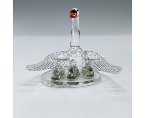 Faceted crystal figurine modeled as a swan mother protecting her three cygnets. This item has its original box. Swarovski aci