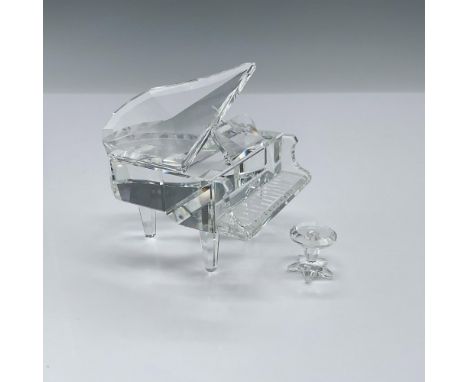 Part of the Cheerful Times collection, this item depicts a clear crystal grand piano with a crystal seat. Swarovski backstamp