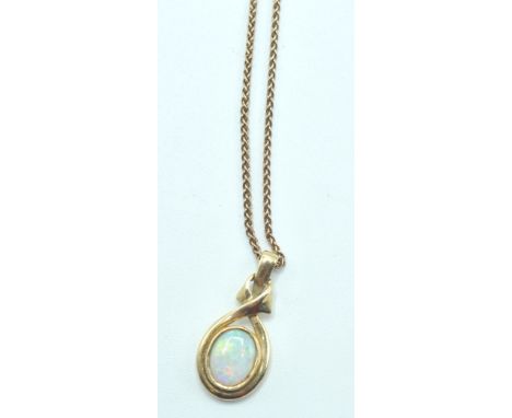 A stamped 9ct gold tracer chain necklace with a pendant set with an opal cabochon. Both the chain and pendant being stamped 3