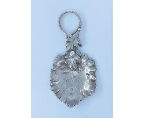 A 19th Century Victorian silver hallmarked caddy spoon in the form of a vine leaf with a moulded handle. Hallmarked Birmingha