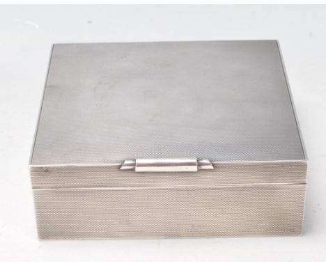 A vintage retro 1960’s silver hallmarked cigarette case. The case of a square form with engine turned decoration and wooden i