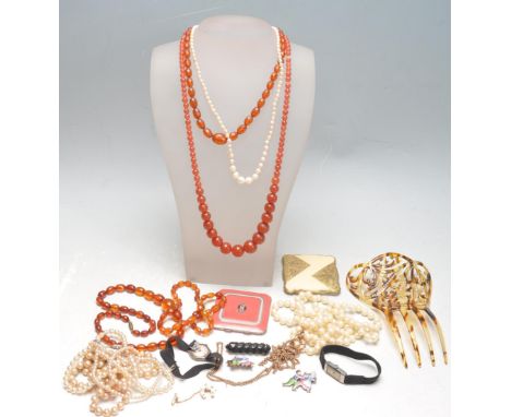 A collection of vintage costume jewellery to include two ladies wristwatches, a Victorian carved jet brooch, a 1930s faux tor