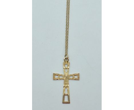 A 9ct gold necklace and crucifix. The necklace having twisted links with spring ring clasp marked 375 along with a large cruc