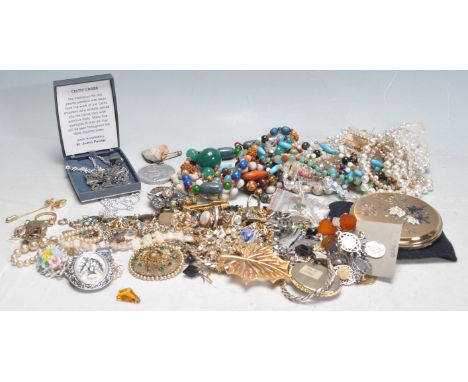 A collection of 20th century vintage costume jewellery to include a stamped silver St Christopher pendant, a yellow metal hea